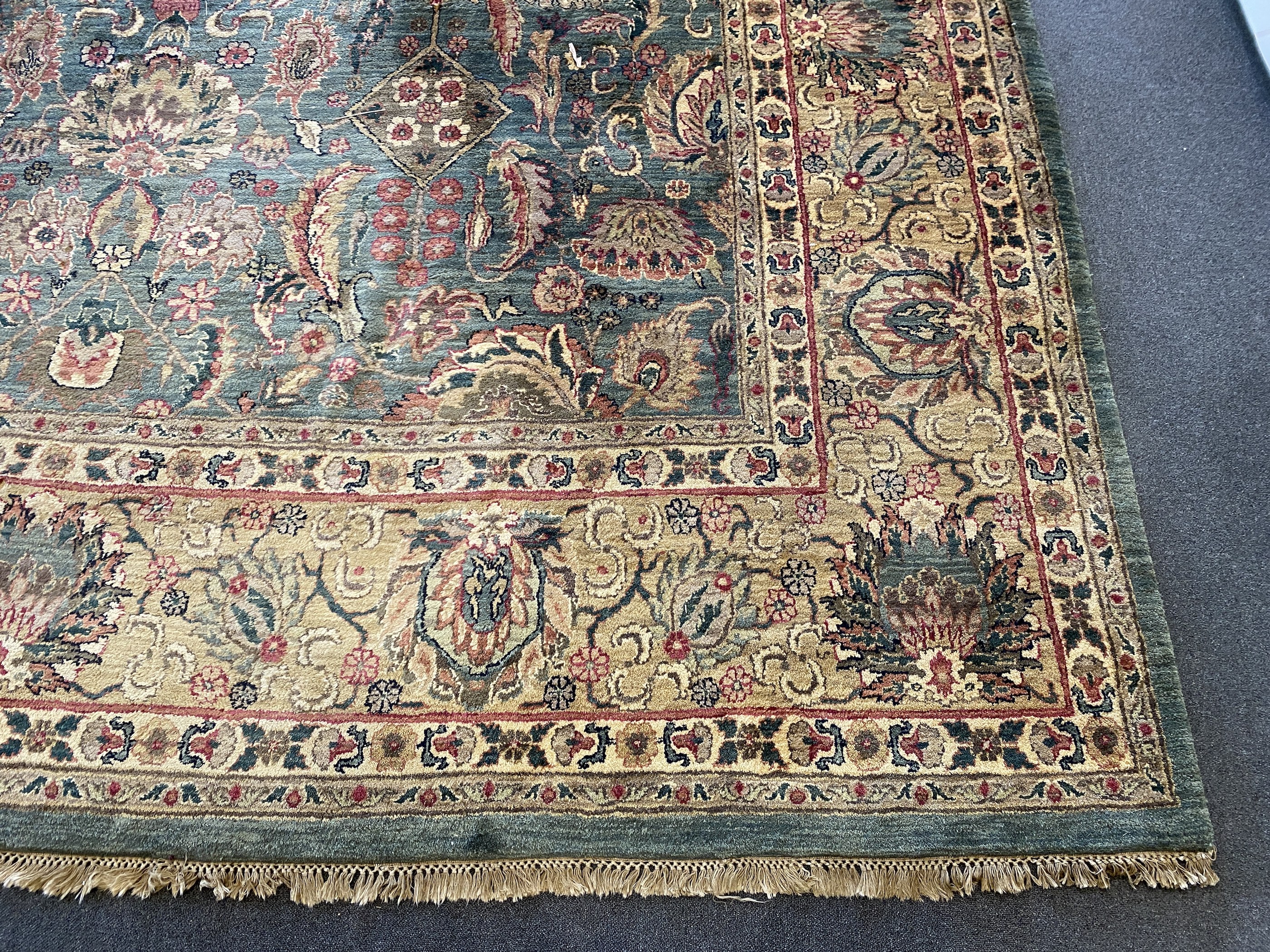 An Indian Persian style sage green ground carpet, 465 x 363cm